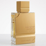 Haramain Amber Oud Gold Edition perfume bottle with a brushed gold metallic finish and clear glass sides, on a white background.